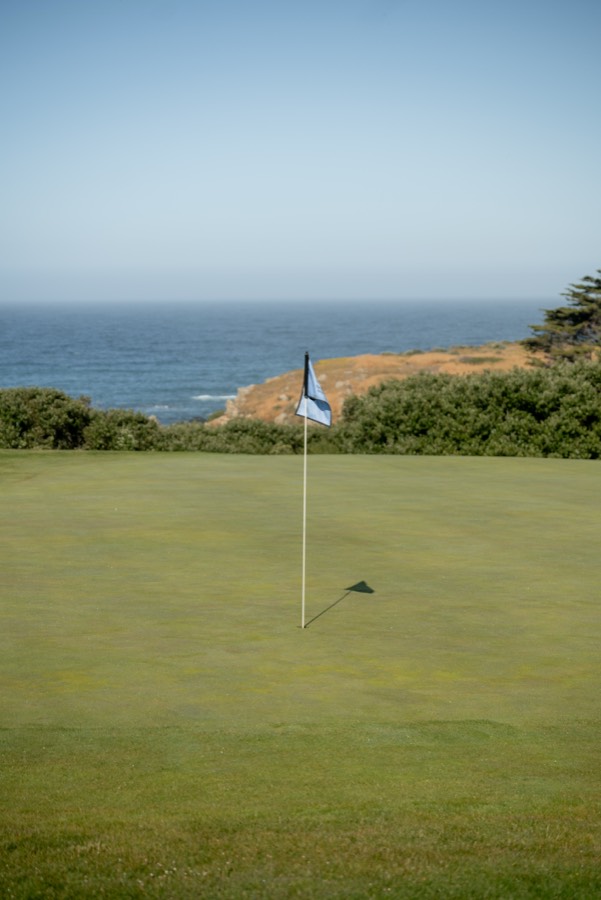 Flag on a green above the ocean